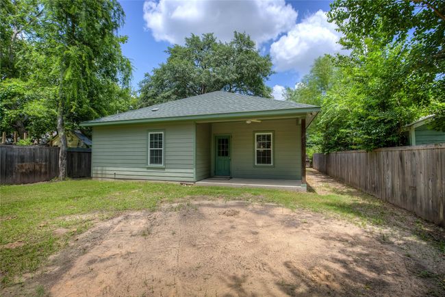 Back of property with a fenced backyard, a patio area, and a shingled roof | Image 33