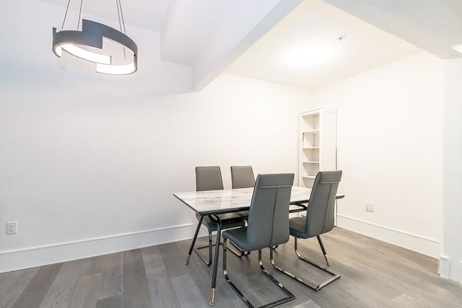 Dining space with baseboards and wood finished floors | Image 13