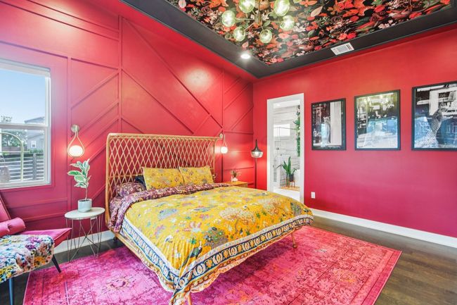 Bedroom featuring multiple windows, a chandelier, and wood finished floors | Image 19