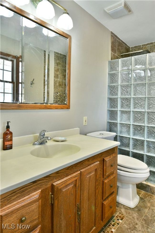 Bathroom with visible vents, toilet, a walk in shower, and vanity | Image 42