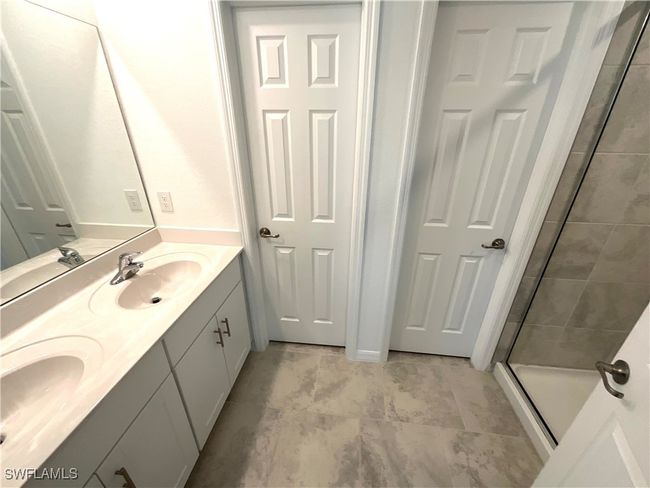 Bathroom featuring double vanity and a stall shower | Image 13