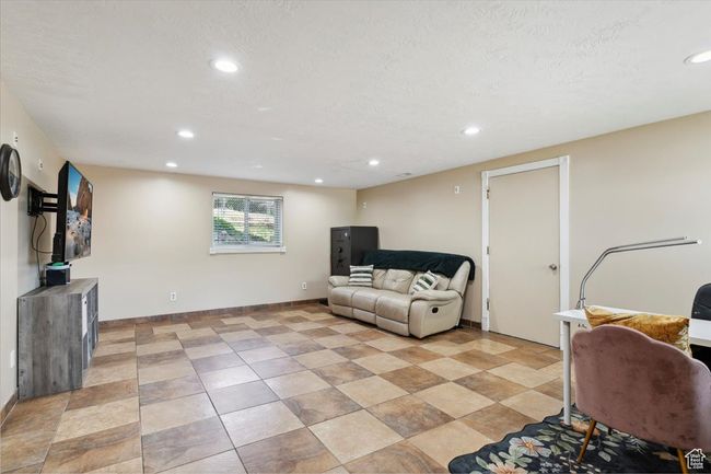 Family room featuring recessed lighting, natural light, tile floors, and a basement walkout | Image 25