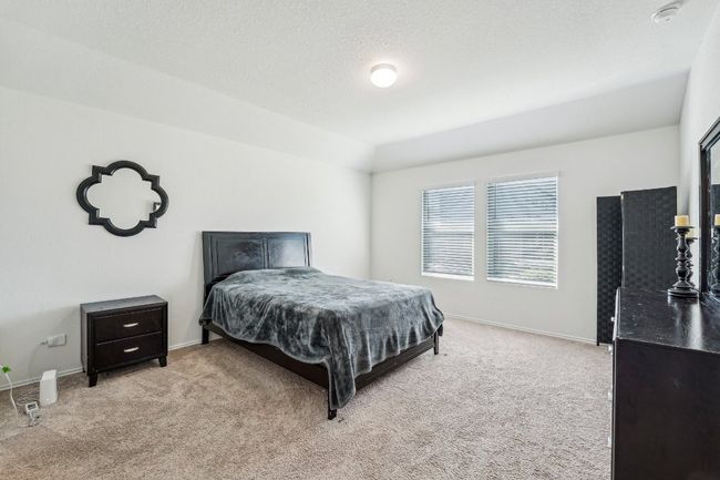 Bedroom with baseboards, carpet flooring, and vaulted ceiling | Image 17