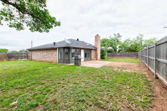 View of yard with a patio, a fenced backyard, and a sunroom | Image 29