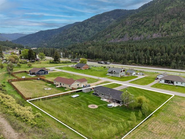 Drone / aerial view of a mountainous background and a heavily wooded area | Image 61