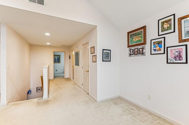 Hall with an upstairs landing, visible vents, recessed lighting, lofted ceiling, and light colored carpet | Image 20