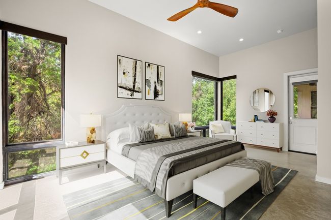 Bedroom with multiple windows, concrete floors, recessed lighting, and ceiling fan | Image 5