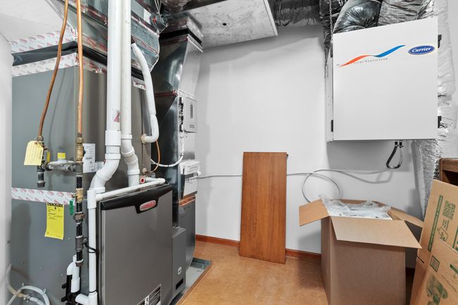 Upper-level mechanical room has recent Lenox HVAC with separate zones for upper-level bedrooms and bonus room / private office. | Image 86