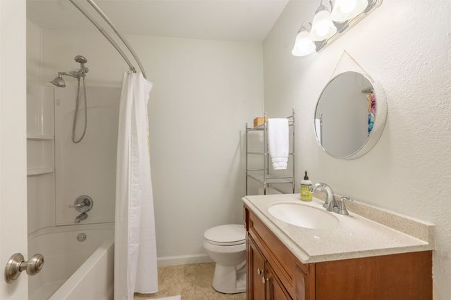 Full bathroom with vanity, shower / tub combo with curtain, and tile patterned flooring | Image 21