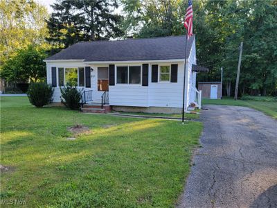 View of front of home featuring a storage shed and a front yard | Image 1