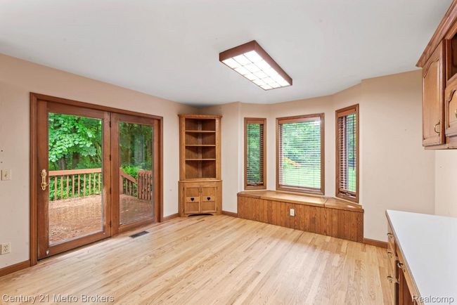 Eating area with built in bookshelves and window seat | Image 8