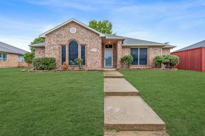 Ranch-style house featuring a front lawn | Image 1