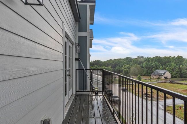 This owner's retreat balcony is the perfect place to start and end the day. It would be extra dreamy with seasonal plants & flowers. | Image 31