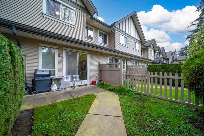 Rear view of house with fence and a lawn | Image 14