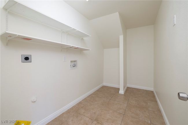 Washroom featuring washer hookup, hookup for an electric dryer, and light tile patterned floors | Image 19