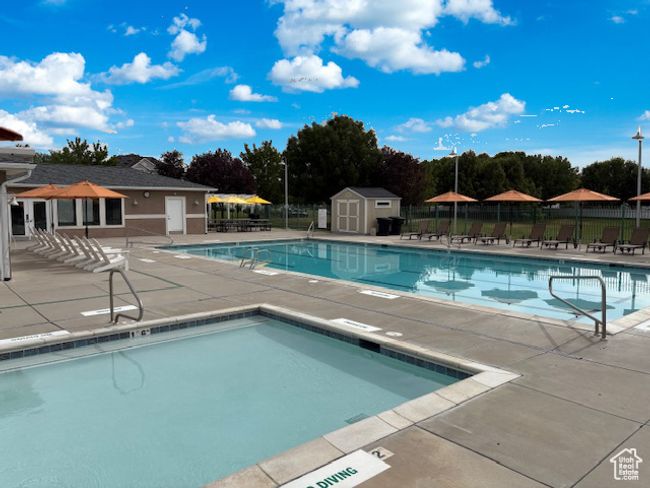 Community pool featuring a patio area and a storage shed | Image 5