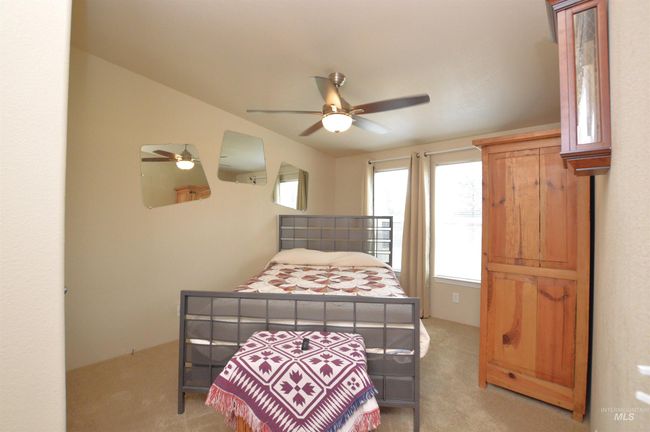 Bedroom featuring light colored carpet and a ceiling fan | Image 19