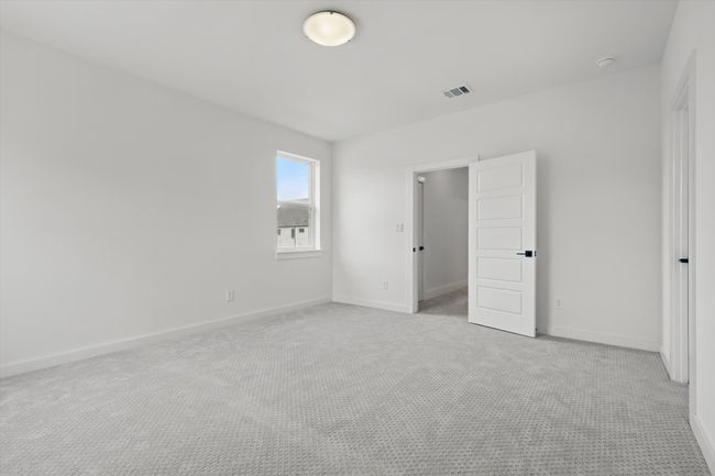 Unfurnished bedroom with light carpet and baseboards | Image 29