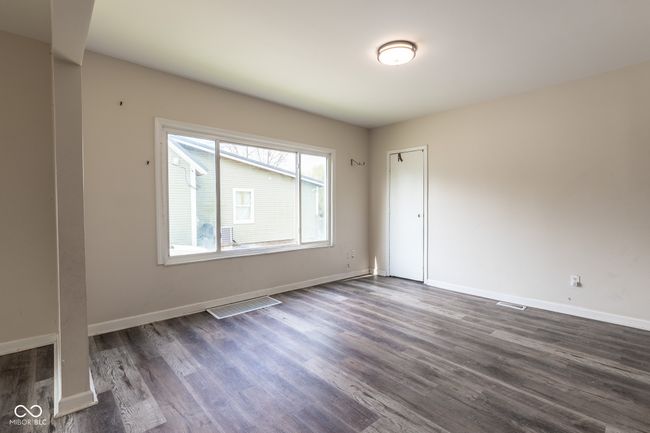 spare room with baseboards, dark wood finished floors, and visible vents | Image 11