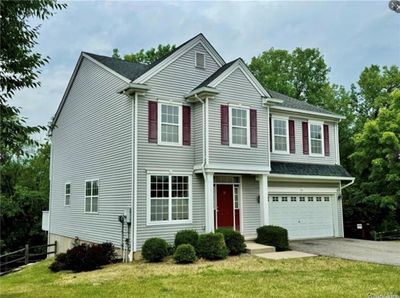 View of front of home featuring a front lawn and a garage | Image 1