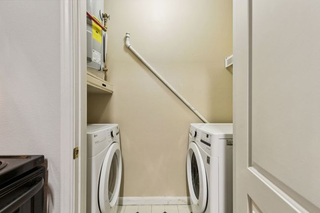 Washroom featuring washing machine and clothes dryer and tile patterned floors | Image 25