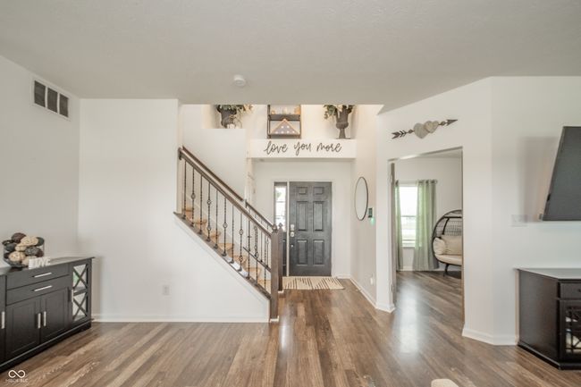 foyer entrance with stairway, wood finished floors, and baseboards | Image 10