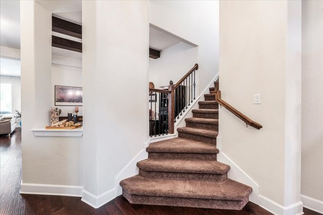 Staircase featuring wood finished floors and baseboards | Image 16