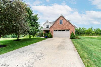 Front facade with a garage and a front yard | Image 2