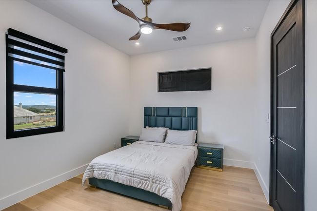 Bedroom with light wood-style flooring, recessed lighting, and a ceiling fan | Image 27
