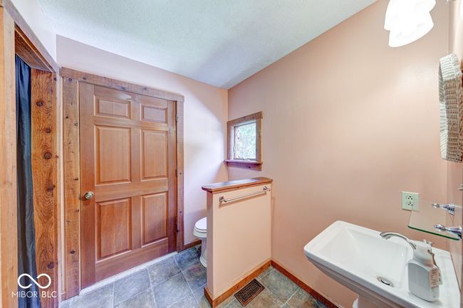 bathroom featuring toilet and a textured ceiling | Image 29