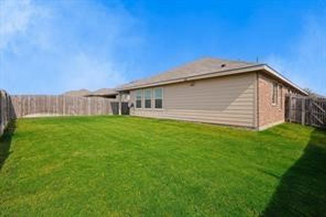 Back of property with a fenced backyard. | Image 18