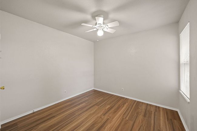 3rd bedroom with ceiling fan and brand new luxury flooring throughout. | Image 25