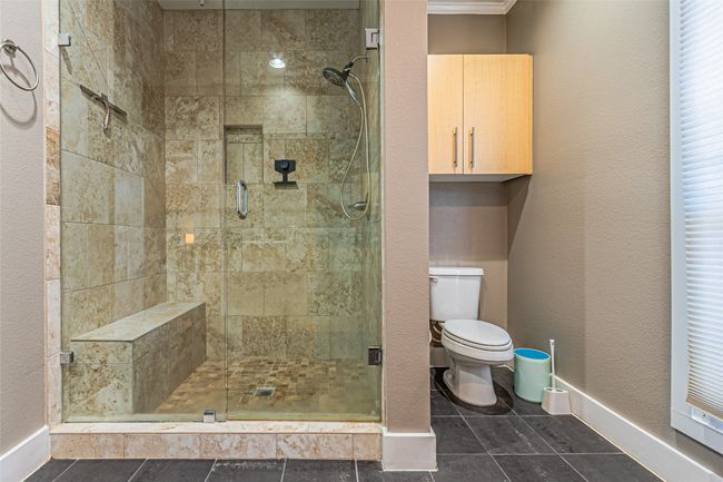 Bathroom featuring a stall shower and tile patterned floors | Image 22