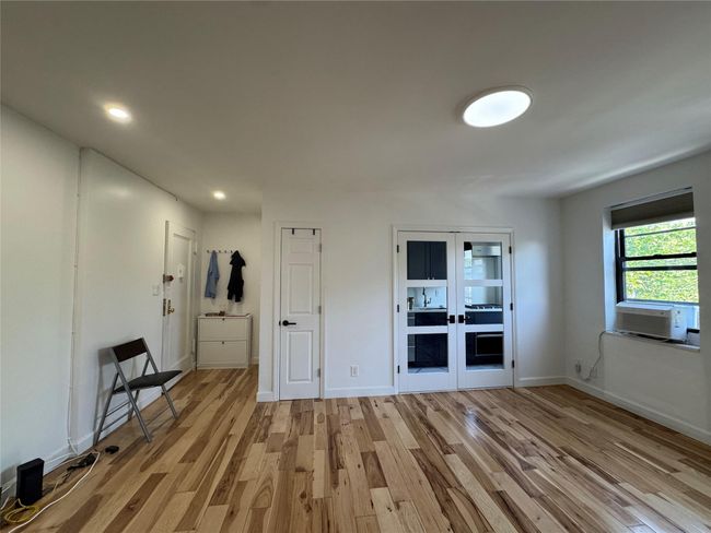 Unfurnished room featuring cooling unit, light wood-style flooring, french doors, and recessed lighting | Image 11