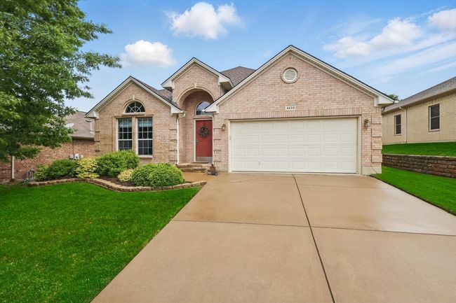 View of front of property with a garage, driveway, a front lawn, and brick​​‌​​​​‌​​‌‌​‌‌​​​‌‌​​‌‌​‌​​​​​‌ siding | Image 4