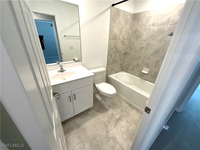 Bathroom featuring vanity and shower / bath combination | Image 17