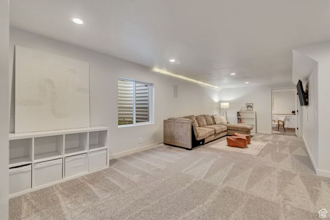Carpeted living area featuring recessed lighting and baseboards | Image 21