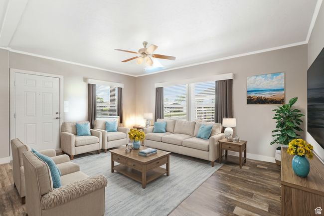 Living area with wood finished floors, baseboards, ceiling fan, and crown molding | Image 5