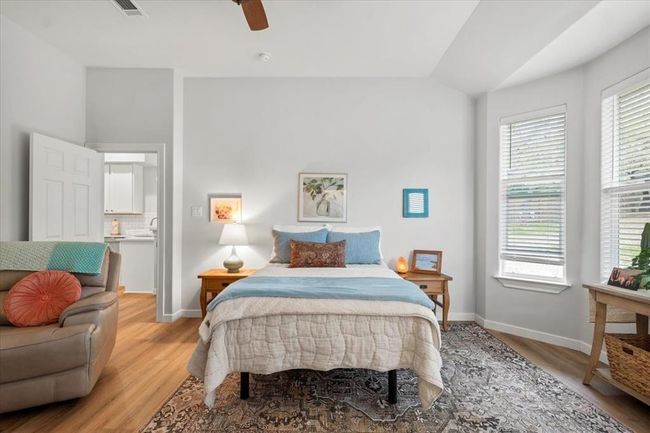 Bedroom featuring baseboards, light wood-style floors, and vaulted ceiling | Image 8