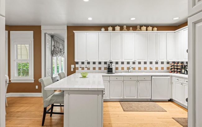 Kitchen with dishwashing machine, a peninsula, a sink, white cabinetry, and recessed lighting | Image 15