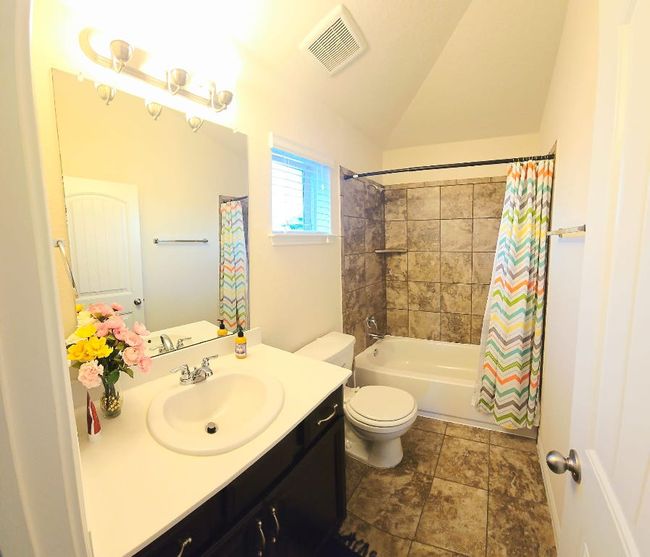 Bathroom with vanity, shower / tub combo with curtain, and lofted ceiling | Image 23