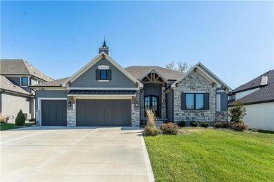 View of front of property with a front yard and a garage | Image 1