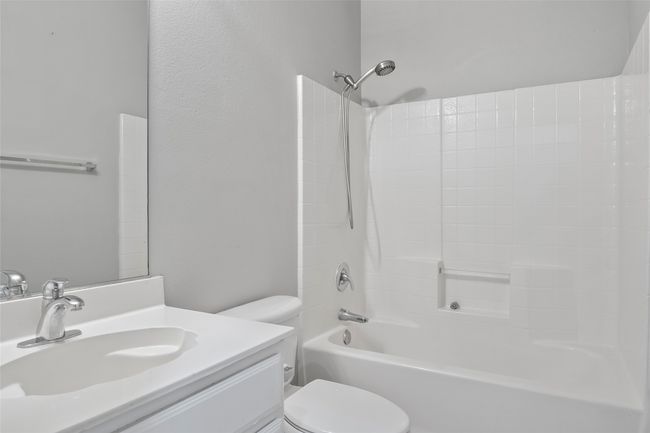 Bathroom featuring toilet, vanity, and bathtub / shower combination | Image 34