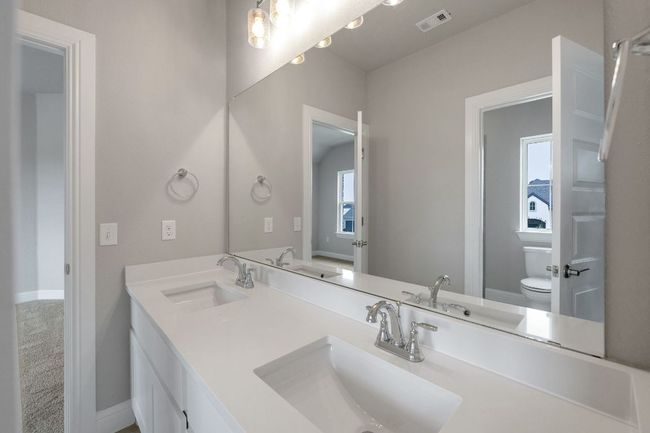 Bathroom with toilet and double vanity | Image 16