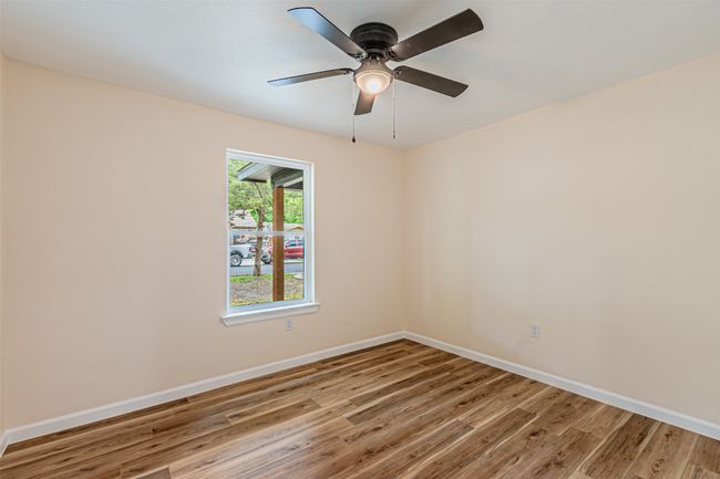 Spare room with baseboards, a ceiling fan, and wood finished floors | Image 17