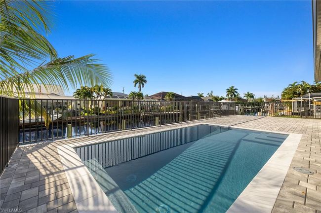 View of swimming pool with a patio area and a water view | Image 36