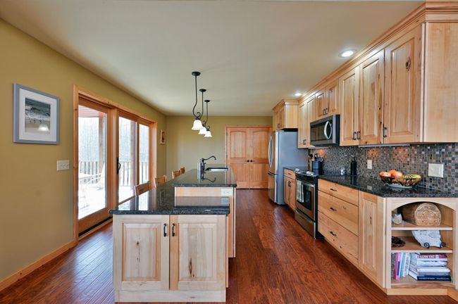 There is nice space between the island and the rest of the kitchen to accommodate several cooks! | Image 26