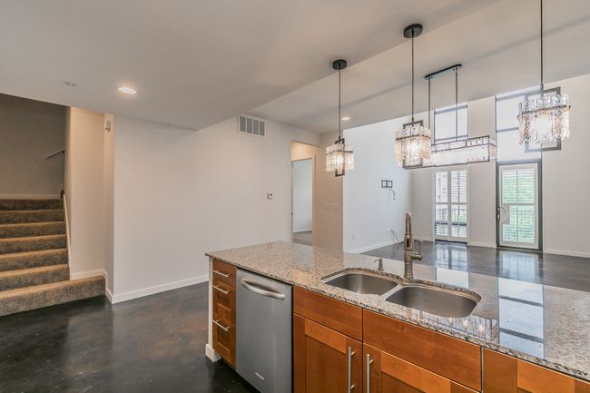 Cook, entertain, and connect in this stunning kitchen featuring granite countertops, stainless appliances, and a spacious island that opens seamlessly into the main living area. | Image 5
