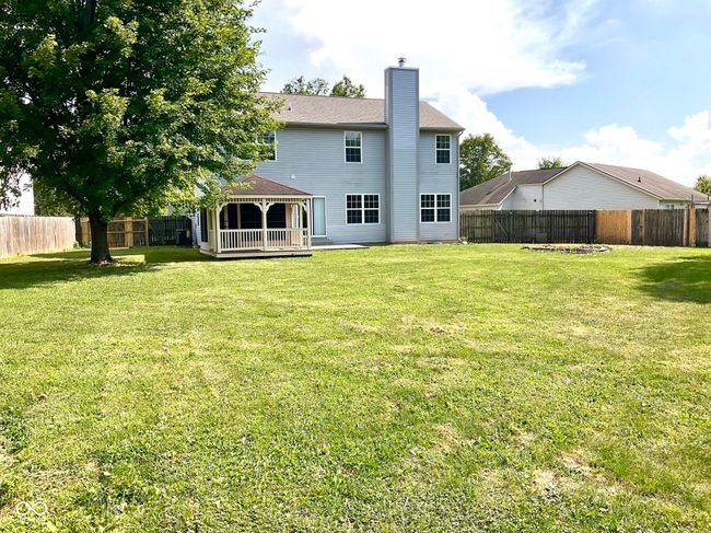 Back of home with massive fenced in private back yard. | Image 46