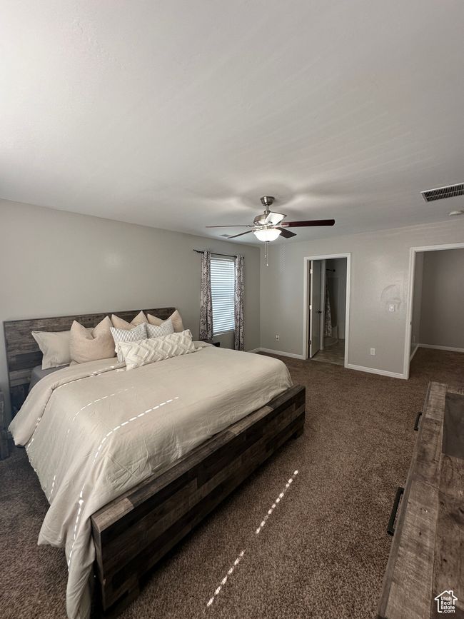 Carpeted bedroom featuring baseboards, visible vents, a spacious closet, and ceiling fan | Image 17